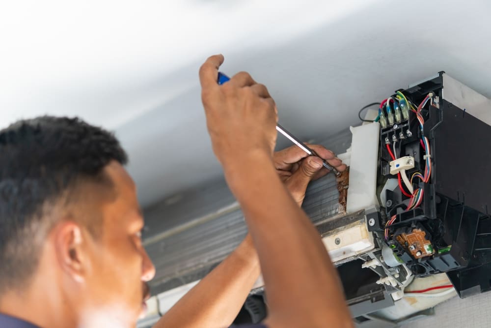 Repairman Fixes Air Conditioning