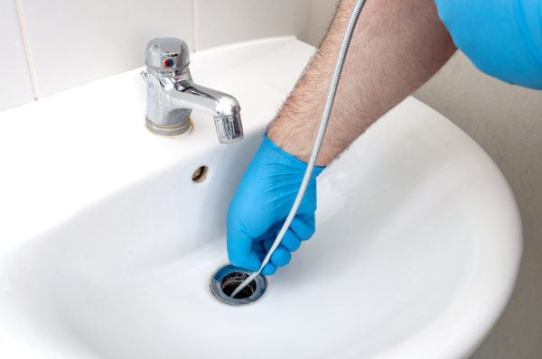 Plumber snaking a clogged drain in las vegas
