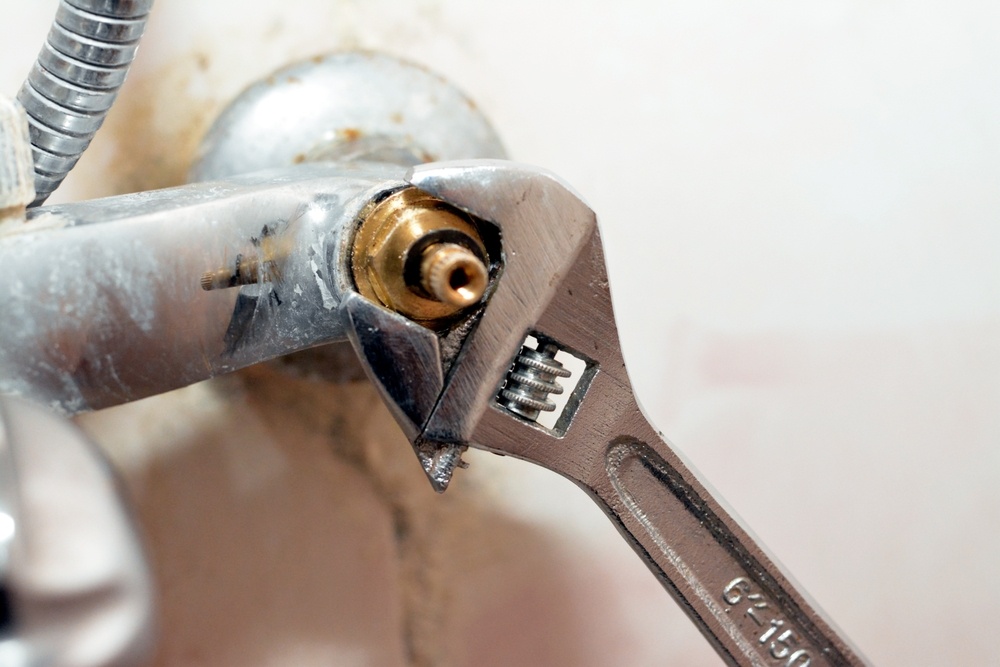 using tools to fix a shower faucet